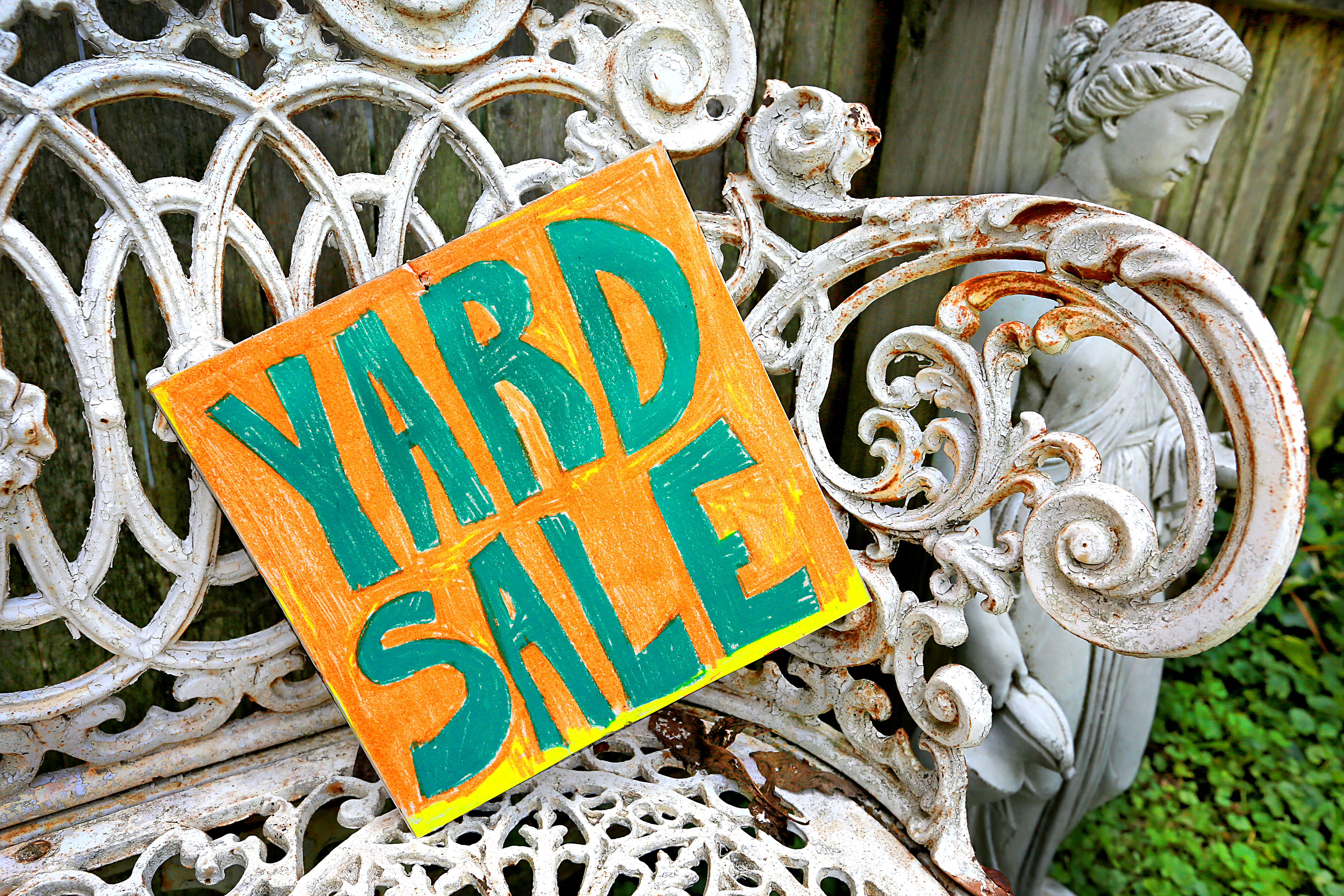 yard sale sign on metal furniture